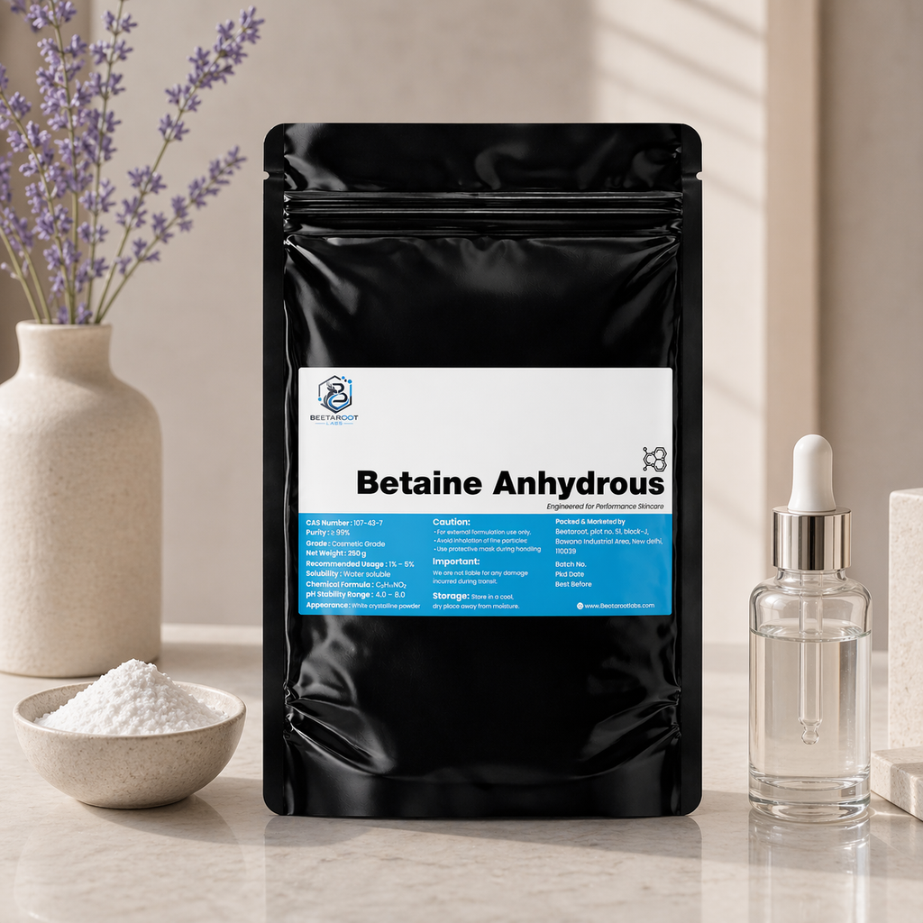 Black package of Betaine Anhydrous with a label, surrounded by a bowl of powder, a bottle, and lavender flowers.